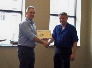 Tim  Schoenfelder, right, receives the IEEE Cedar Rapids Section’s 2013 Ted A. Hunter Award  from John Nirschl, the 2012 recipient of the Section’s Ted A. Hunter Award